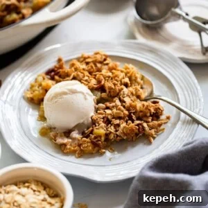 rhubarb crisp served on plate with vanilla ice cream