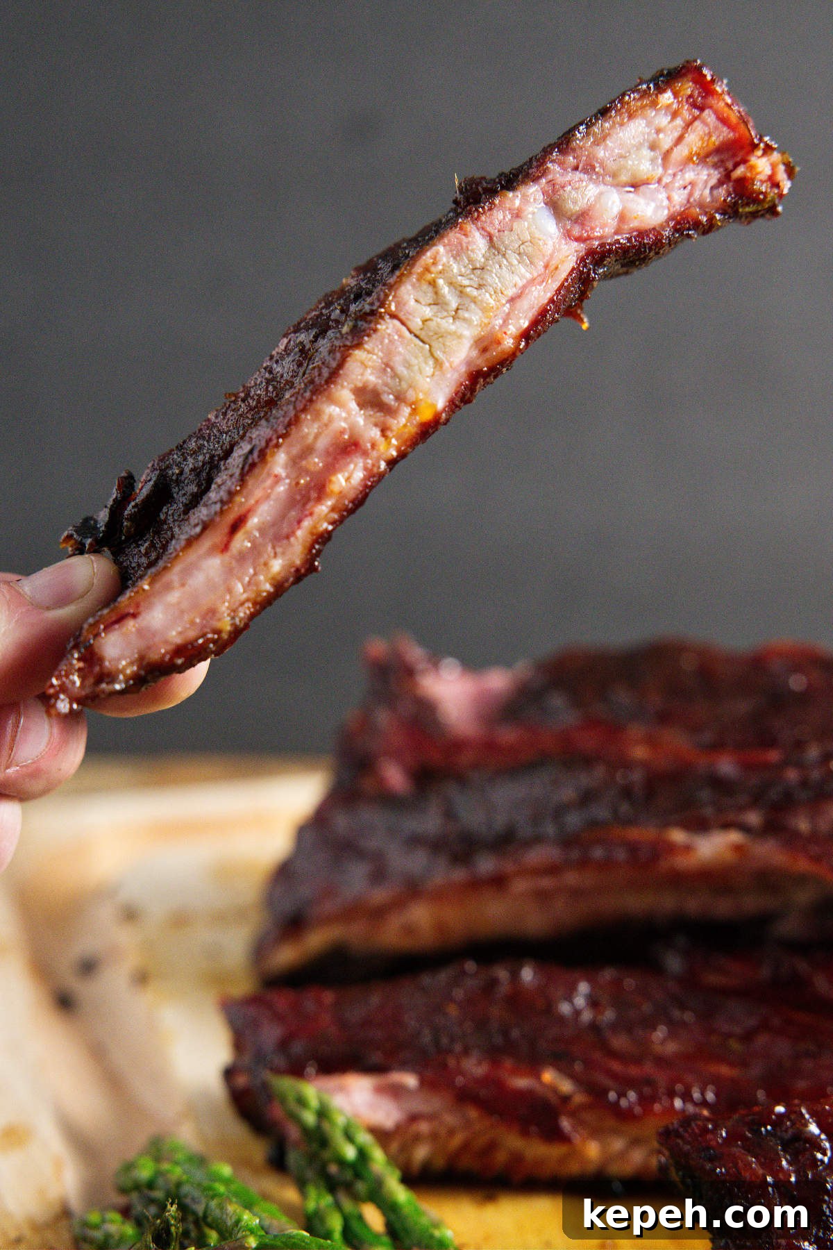 Perfect 3-2-1 Smoked Ribs Recipe for Tender, Fall-Off-the-Bone Results 2 traeger smoked pork spare ribs, sliced and one being held