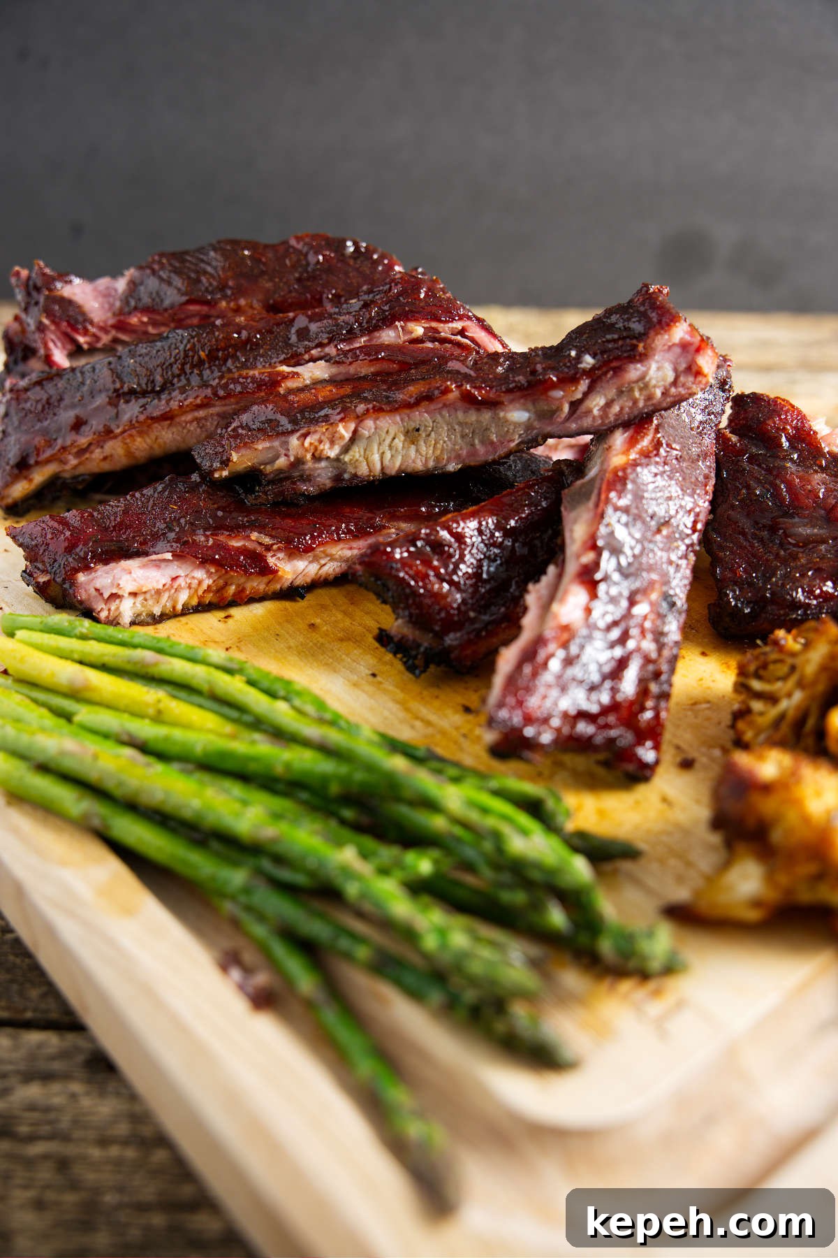 Perfect 3-2-1 Smoked Ribs Recipe for Tender, Fall-Off-the-Bone Results 3 sliced pork 3-2-1 ribs on butcher board