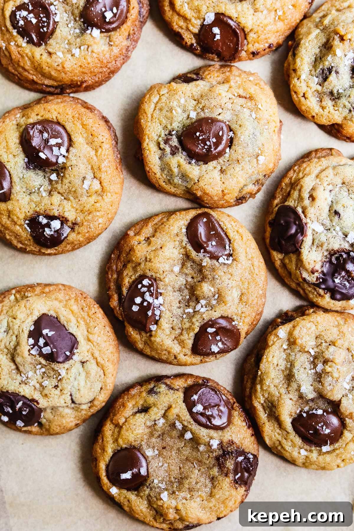 Perfect Small-Batch Chocolate Chip Cookie Recipe (Makes 6) 2 Small batch salted chocolate chip cookies on a parchment paper-lined sheet pan.