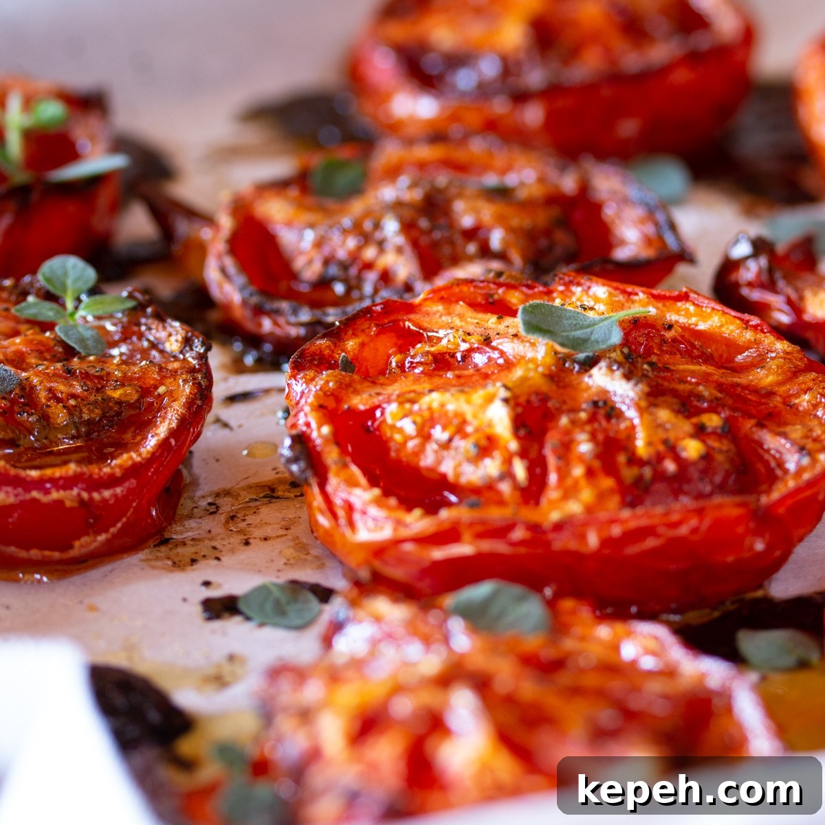Balsamic-Roasted Tomatoes — Quick 5-Minute Prep Recipe 4 Balsamic roasted tomato halves freshly roasted on a parchment sheet lined baking sheet.