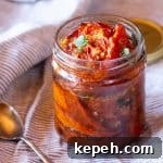 Balsamic-Roasted Tomatoes — Quick 5-Minute Prep Recipe 6 A jar of balsamic roasted tomatoes and olive oil for preserving.