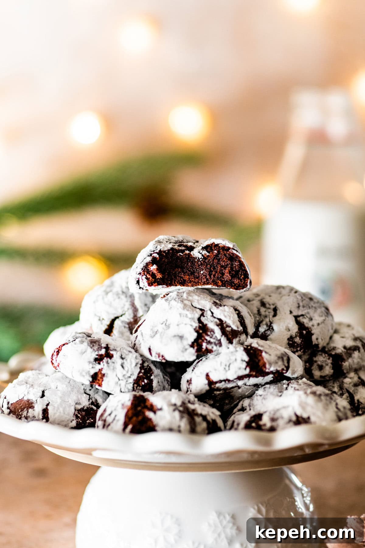 Chocolate Crinkle Cookies on a platter ready to serve with Christmas lights in the background.