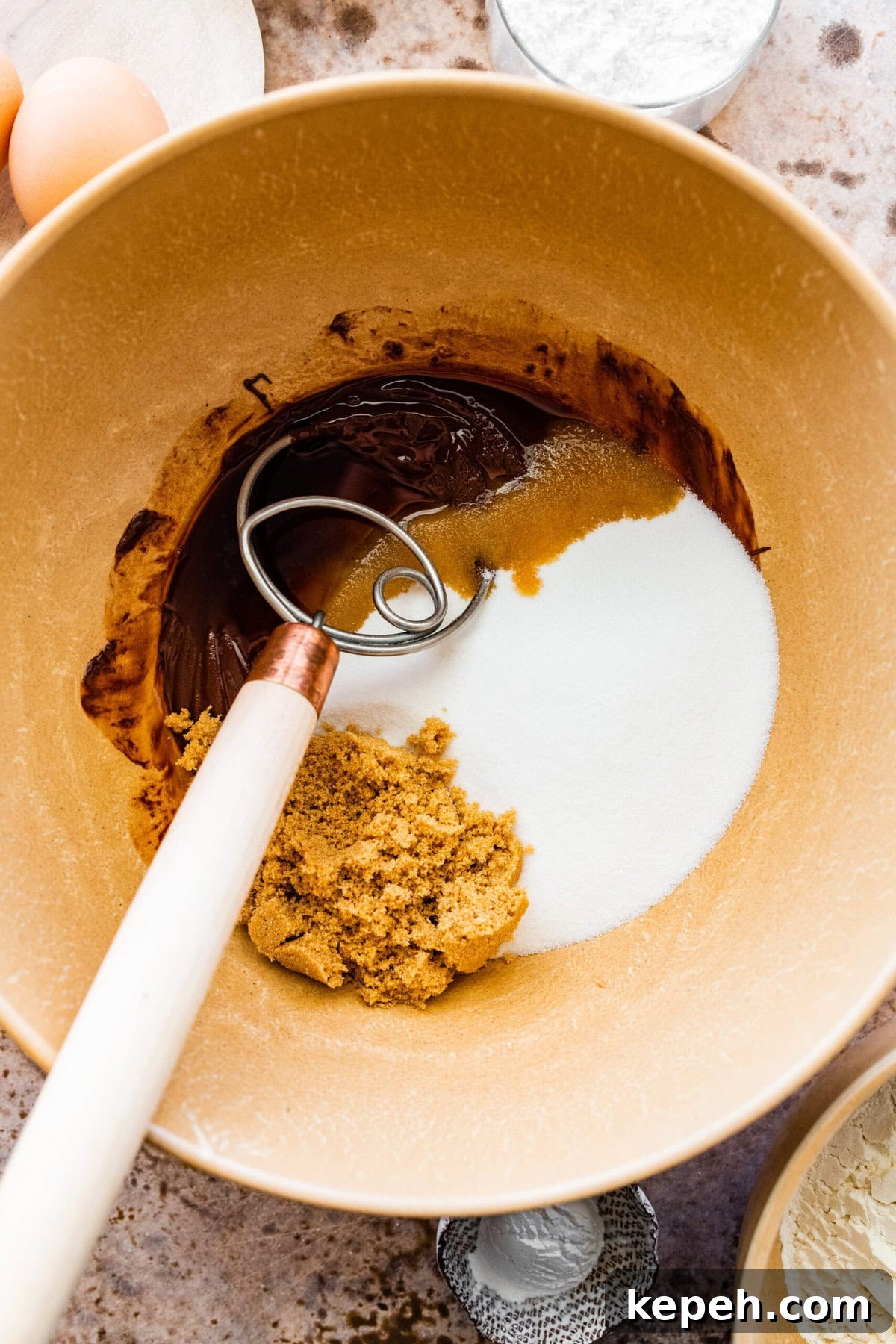 How to make chocolate crinkle cookies step-by-step: add the sugars and beat well to combine.
