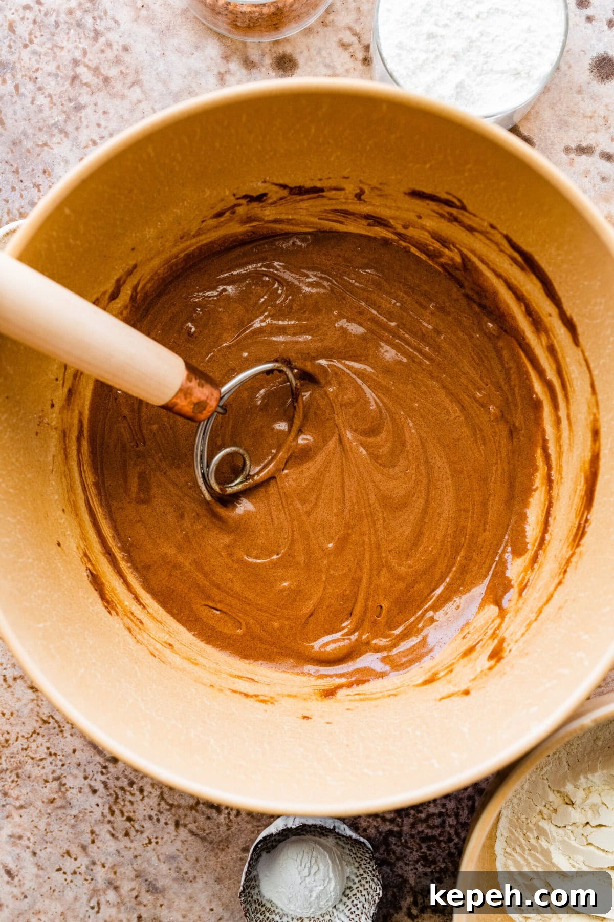Whish in a bowl of chocolate crinkle cookie batter.