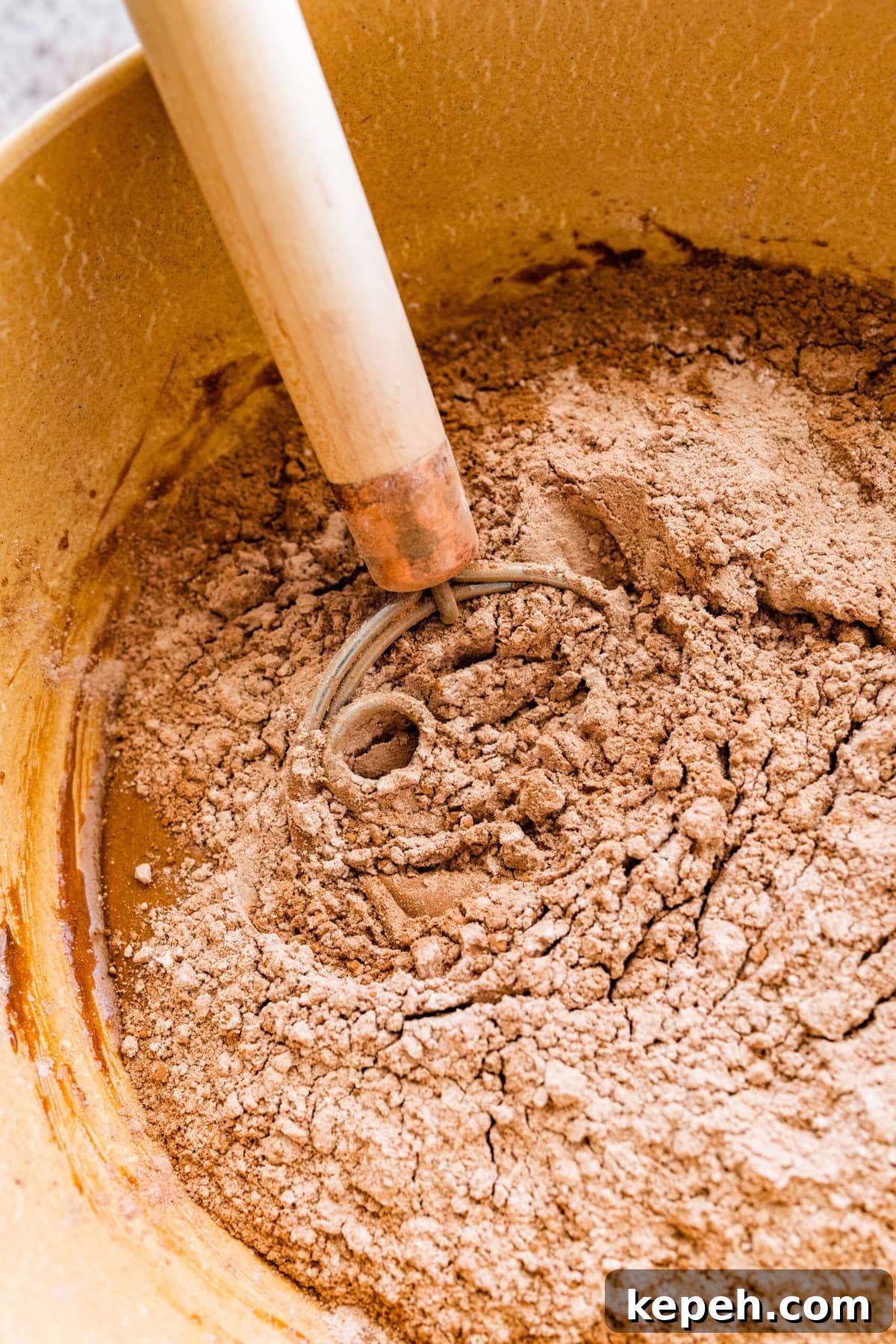 How to make chocolate crinkle cookies step-by-step: add the dry ingredients to the wet ingredients and mix to combine.