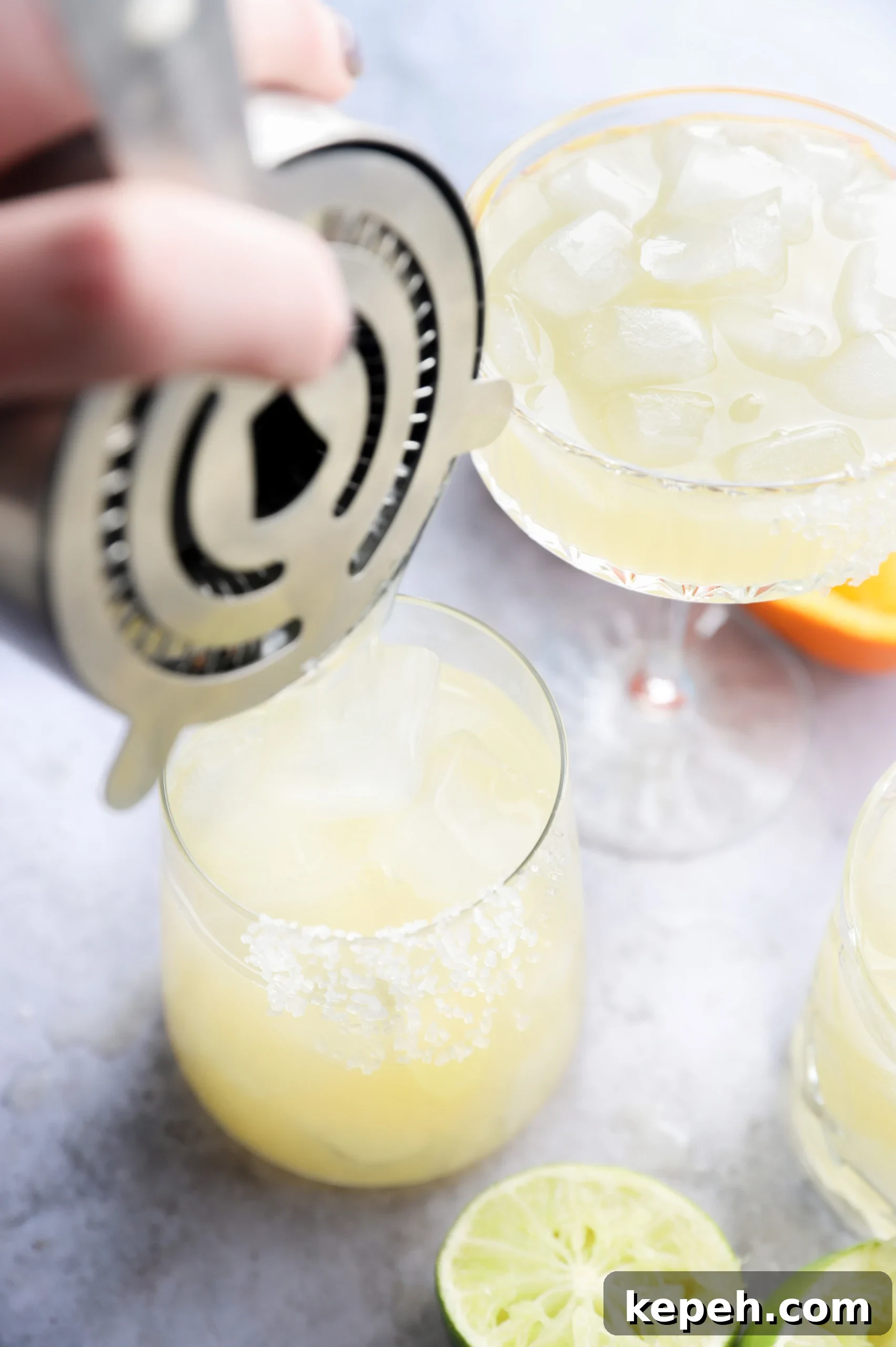 Texas Margarita Recipe: Classic Tex-Mex Cocktail Guide 9 Pouring a tequila cocktail into a rimmed glass picture