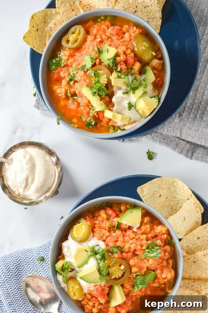 Hearty Red Lentil Chili with Smoky Tomatoes and Spices 3 Two bowls of lentil chili with tortilla chips on the side