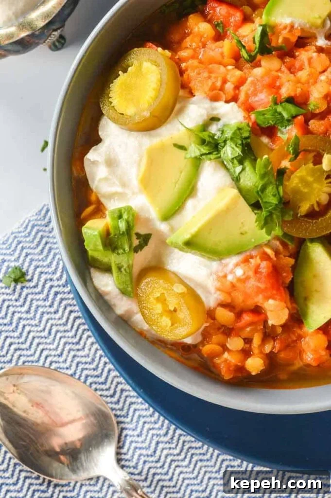 Hearty Red Lentil Chili with Smoky Tomatoes and Spices 4 A bowl of chili with jalapeños and tofu sour cream