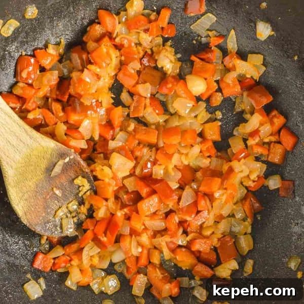 Hearty Red Lentil Chili with Smoky Tomatoes and Spices 5 Chopped red peppers and onions in a pan