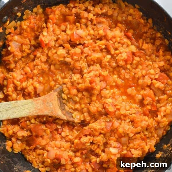 Hearty Red Lentil Chili with Smoky Tomatoes and Spices 7 Red lentils and tomato in a pan