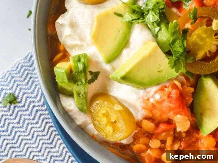 A bowl of chili with jalapeños and tofu sour cream