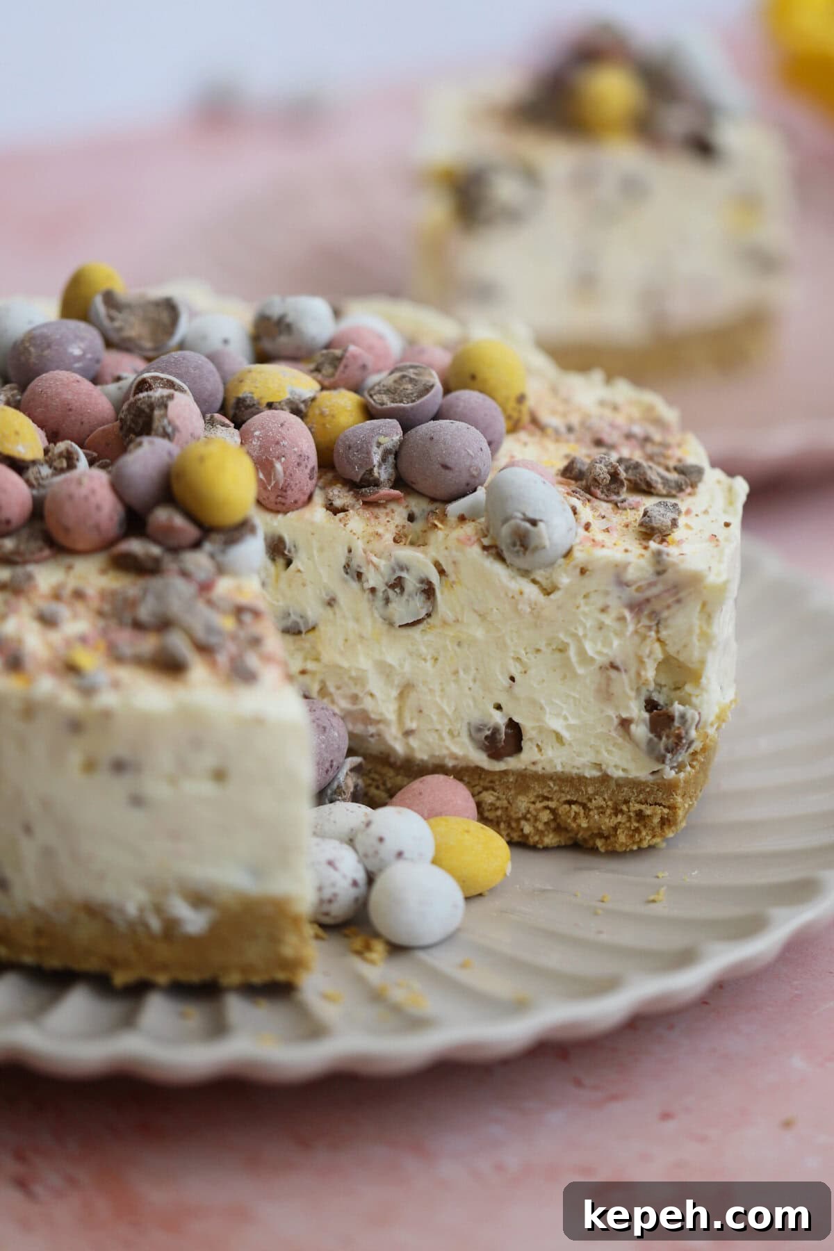 Mini Egg Cheesecake Recipe: Creamy No-Bake Easter Dessert 2 A mini egg cheesecake with a slice cut from it.