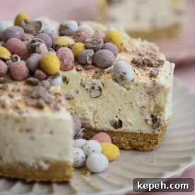Mini Egg Cheesecake Recipe: Creamy No-Bake Easter Dessert 12 A mini egg cheesecake with a slice cut from it.