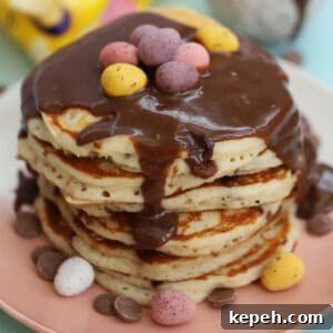 A stack of mini eggs pancakes with chocolate ganache on top.