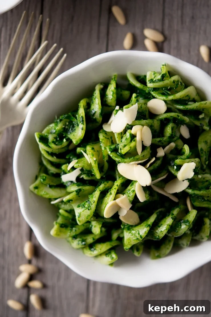 A close up of pesto pasta sauce with fusilli pasta in a white bowl A close up of pesto pasta sauce with fusilli pasta in a white bowl