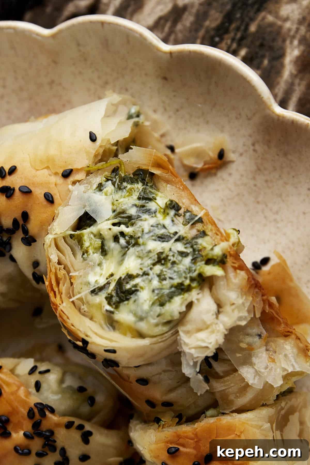 The filling of a phyllo spanakopita roll.