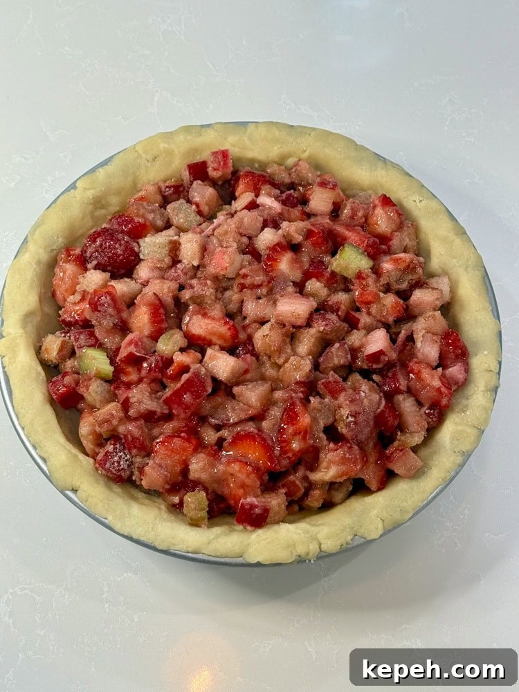 Strawberry Rhubarb Pie Recipe: Sweet-Tart Summer Dessert 11 strawberry and rhubarb filling inside the crust