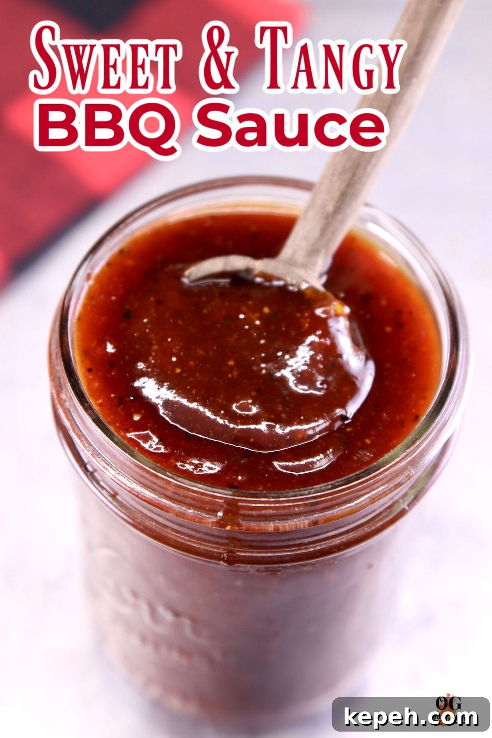 Sweet and Tangy BBQ Sauce in a jar with a spoon - text overlay for pinterest