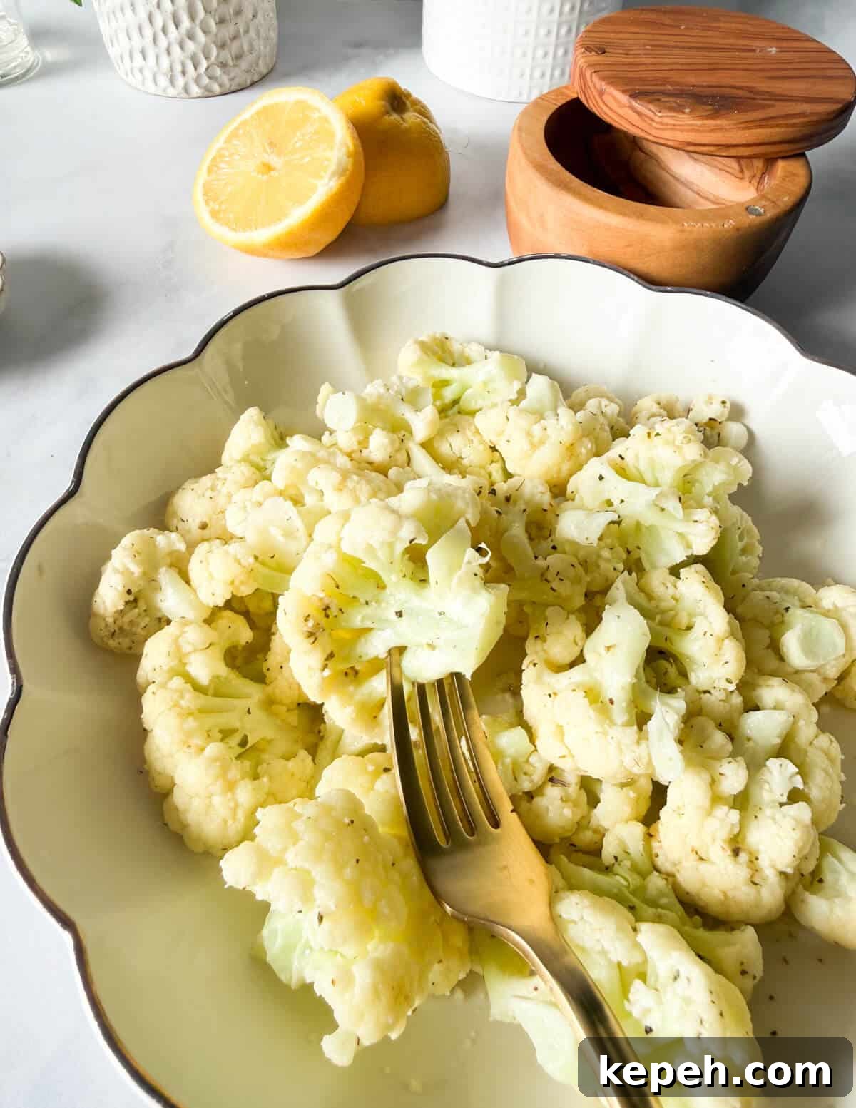 Garlic Butter Microwave Cauliflower Recipe for Quick Sides 2 a bowl of steamed cauliflower with garlic butter sauce.