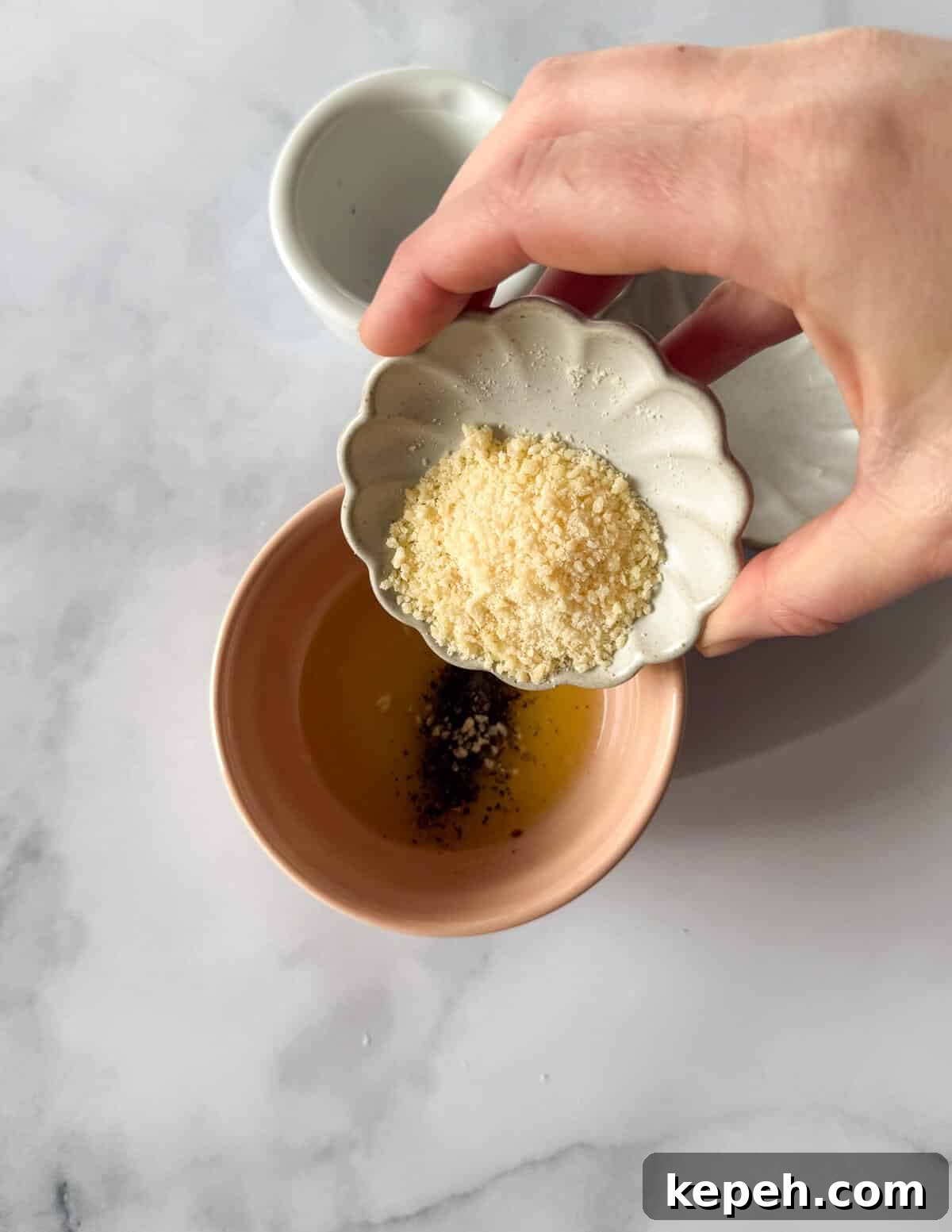 Garlic Butter Microwave Cauliflower Recipe for Quick Sides 7 pouring parmesan cheese into melted garlic butter.