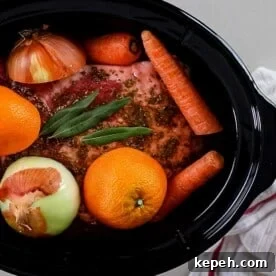 pork, seasonings orange and onion in slow cooker