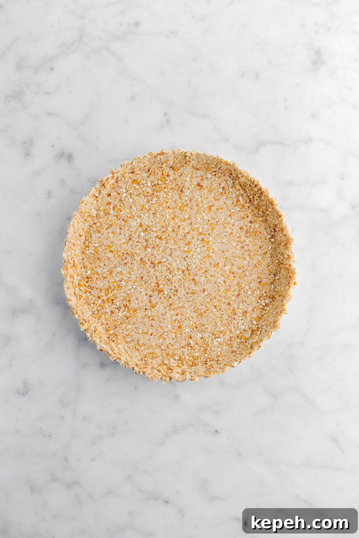 Strawberry Mascarpone Tart with Crunchy Pretzel Crust 11 packed pretzel crust on marble surface.