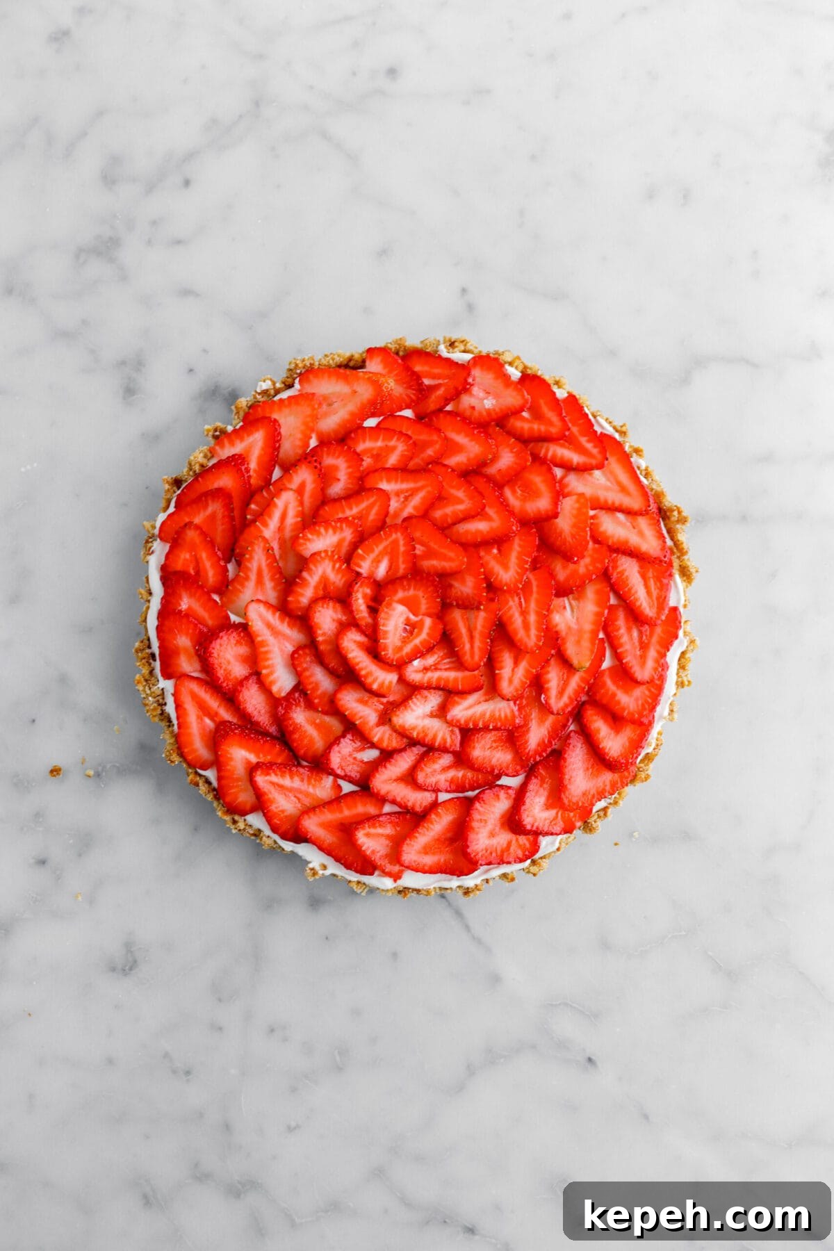 Strawberry Mascarpone Tart with Crunchy Pretzel Crust 17 sliced strawberries laid in a circle patter on top of tart.