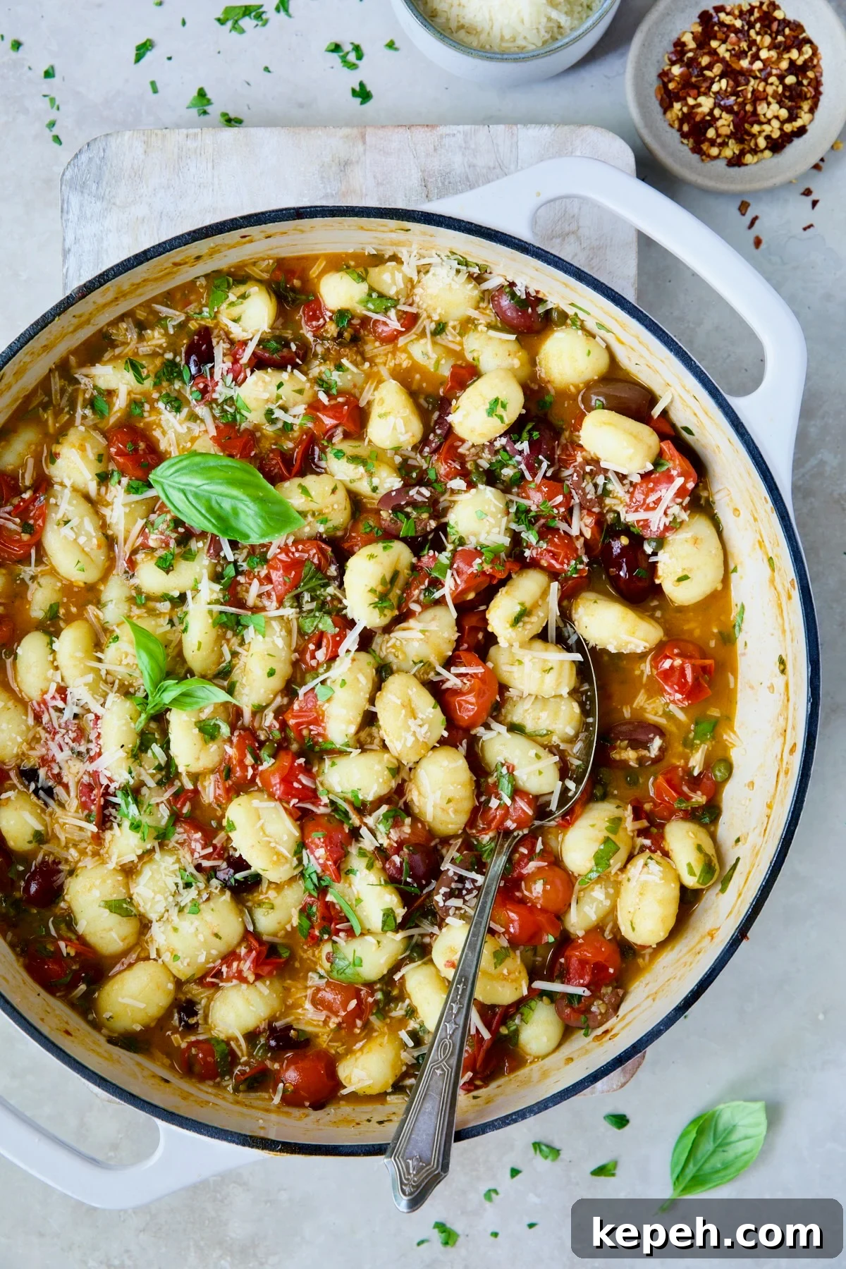 Gnocchi in Cherry Tomato Puttanesca Sauce 2 Gnocchi with Cherry Tomato Puttanesca Sauce garnished with fresh parsley, basil and Parmesan cheese.