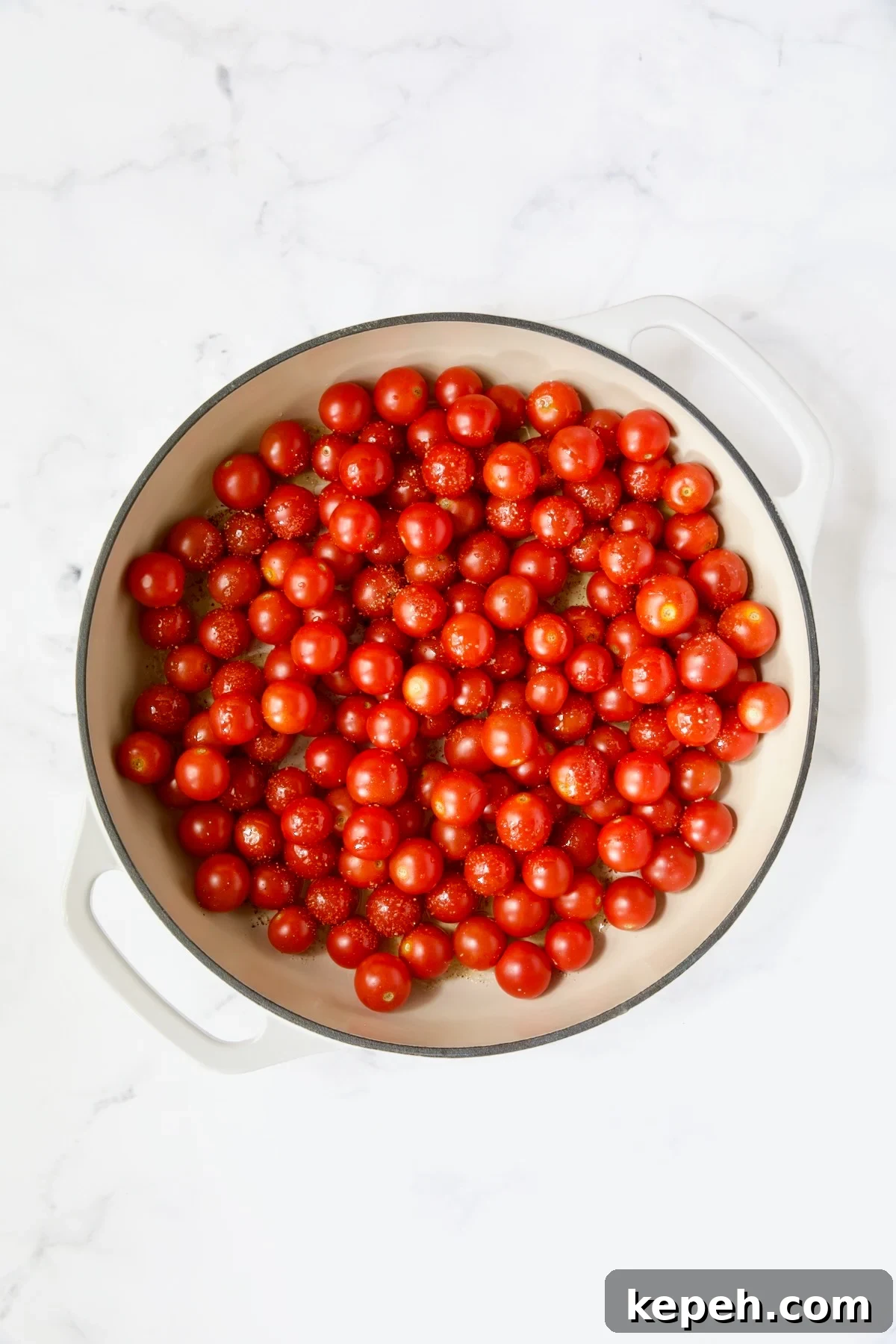 Gnocchi in Cherry Tomato Puttanesca Sauce 5 Uncooked cherry tomatoes in white enamel cast iron skillet.
