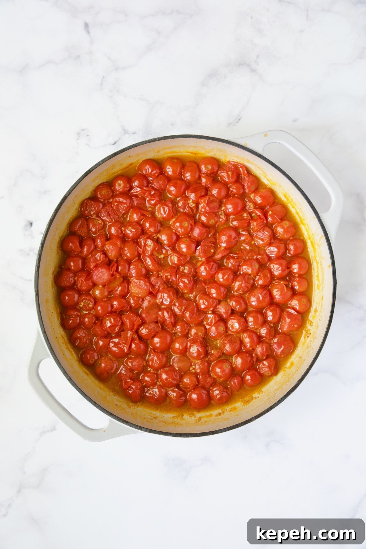 Gnocchi in Cherry Tomato Puttanesca Sauce 6 Cooked cherry tomatoes in white enamel cast iron skillet.