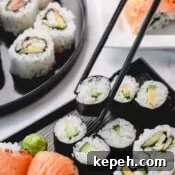 Homemade Sushi Roll Recipe: Step-by-Step Guide for Perfect Rolls 10 Cucumber rolls with one piece picked up with chopsticks.