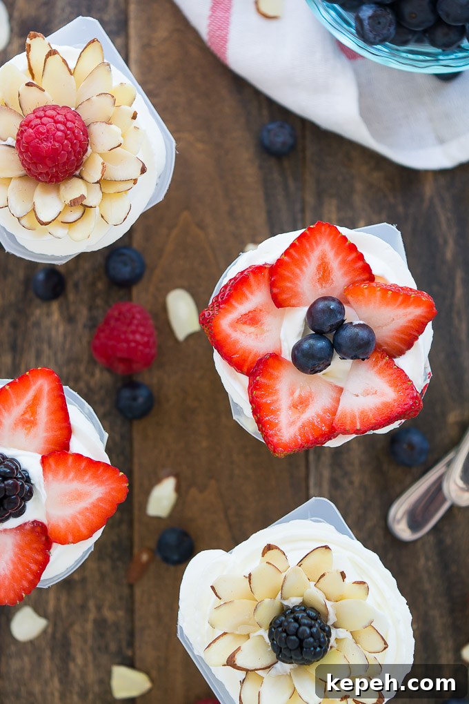 Berry Blossom Pudding Cups: Creamy Parfait Recipe with Fresh Berries 3 Fresh fruit mixed into vanilla Snack Packs and topped with an arrangement of berries and almonds in the shape of a flower. #SnackPackMixins #Ad