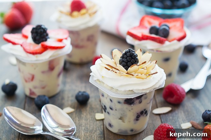 Berry Blossom Pudding Cups: Creamy Parfait Recipe with Fresh Berries 4 Fresh fruit mixed into vanilla Snack Packs and topped with an arrangement of berries and almonds in the shape of a flower. #SnackPackMixins #Ad