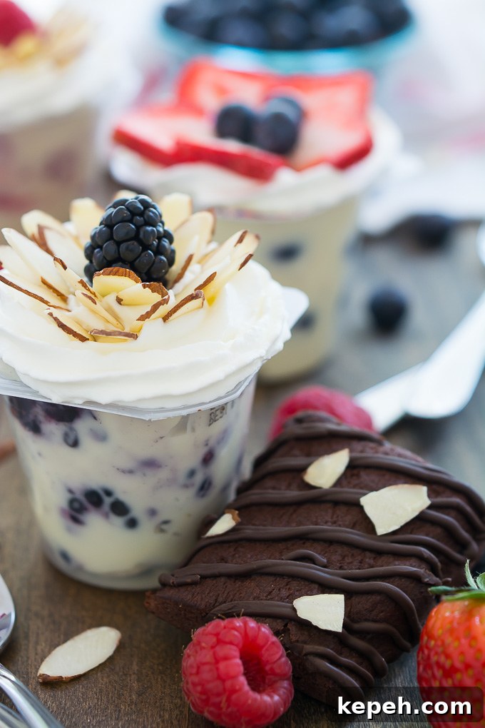 Berry Blossom Pudding Cups: Creamy Parfait Recipe with Fresh Berries 5 Fresh fruit mixed into vanilla Snack Packs and topped with an arrangement of berries and almonds in the shape of a flower. #SnackPackMixins #Ad