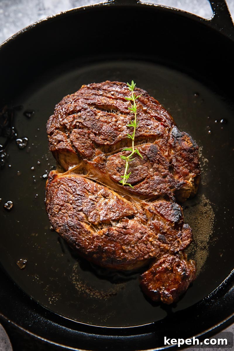 cooked ribeye on cast iron pan