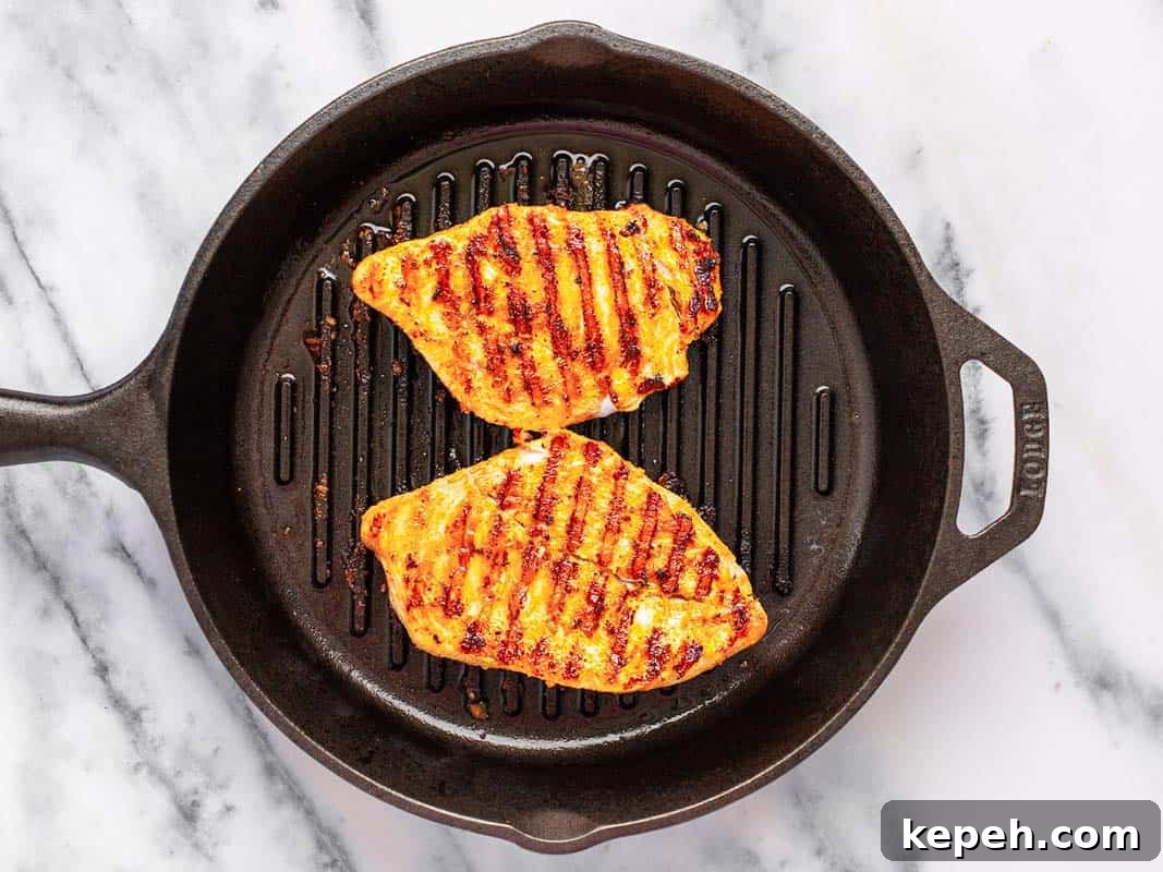 Grilled chicken in a round cast iron grill pan. 
