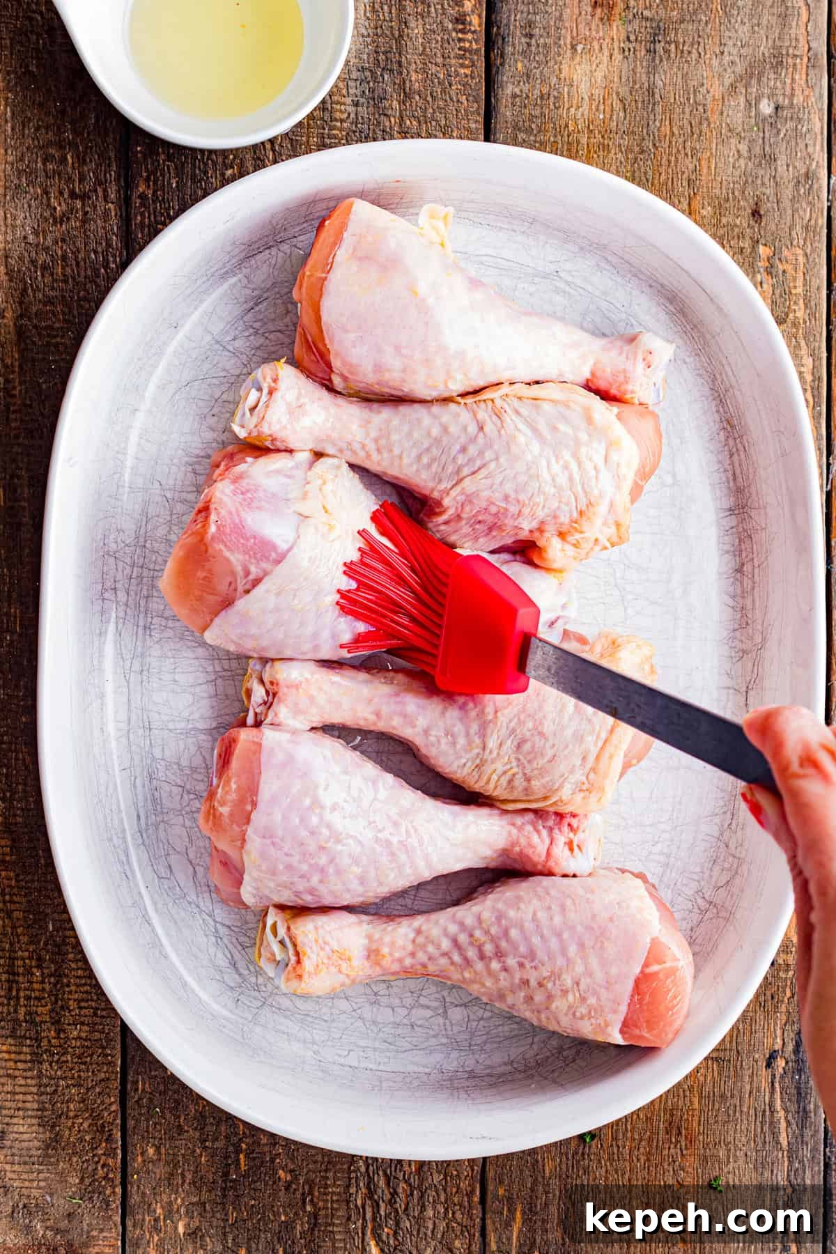Perfectly Crispy Air Fryer Chicken Drumsticks Recipe 6 Brushing chicken drumsticks with olive oil.