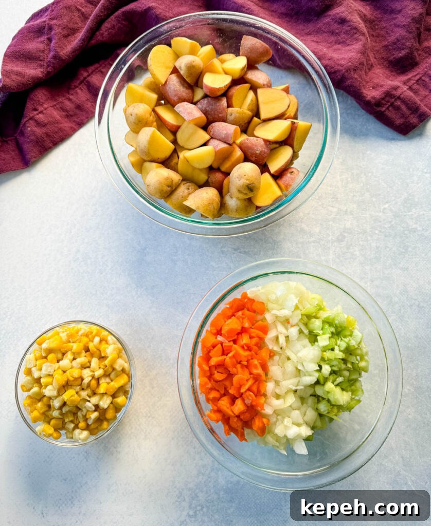 Creamy Salmon and Sweet Corn Chowder Recipe 5 raw potatoes, corn, carrots, celery, and onions in separate glass bowls