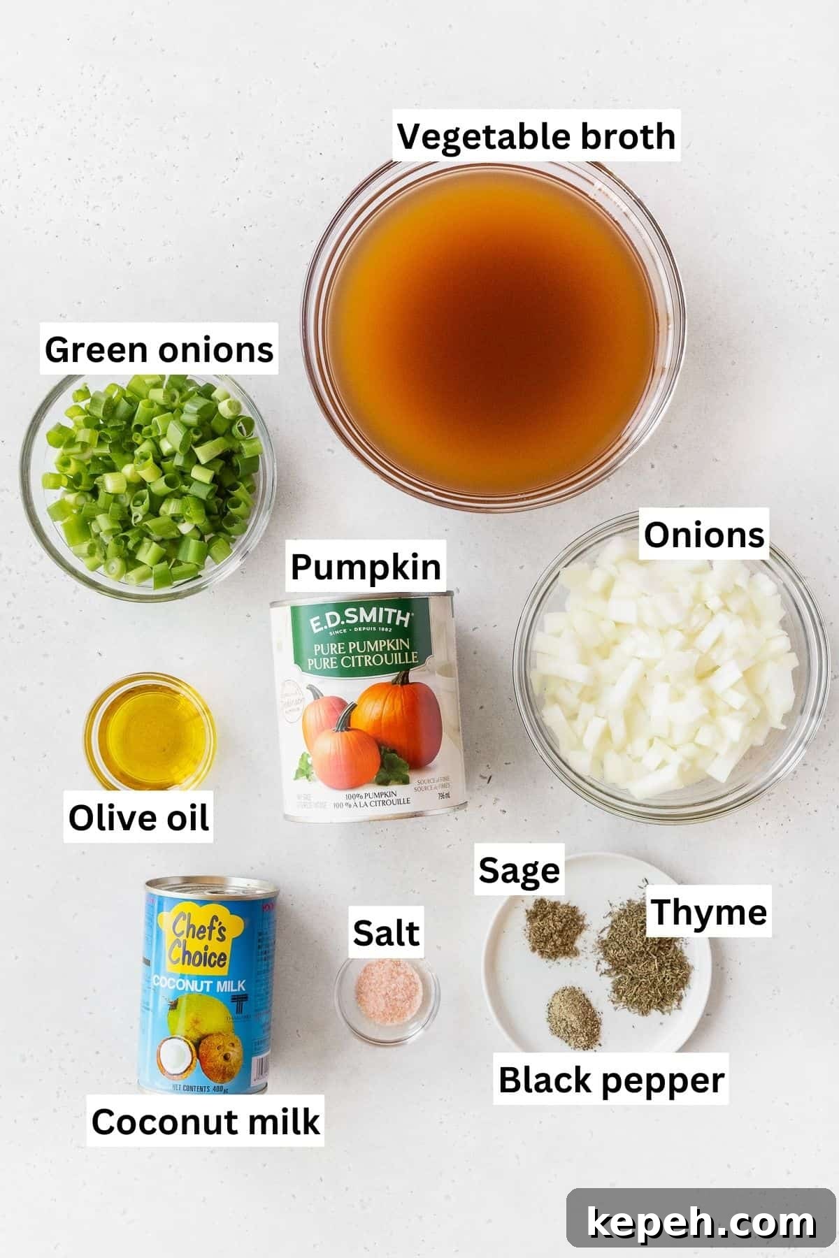 Creamy Plant-Based Pumpkin Soup Recipe for Fall Comfort 3 Ingredients needed to make vegan pumpkin bisque soup measured out into bowls on a white table with text overlay.
