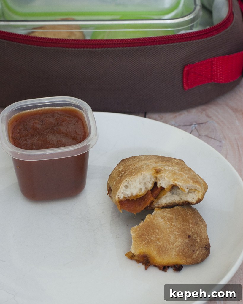 Mini Pepperoni Calzone Recipe: Crispy, Cheesy Hand Pies 2 You'll be parent of the year when you send your kids back to school with mini pepperoni calzones. They're easy to make in bulk and freeze. #SundaySupper TheRedheadBaker.com