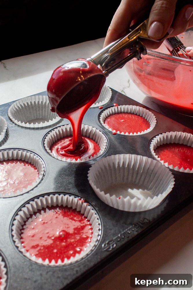 Decadent Red Velvet Cupcakes Recipe for Perfect Moist Cakes 5 pouring red velvet cupcake batter