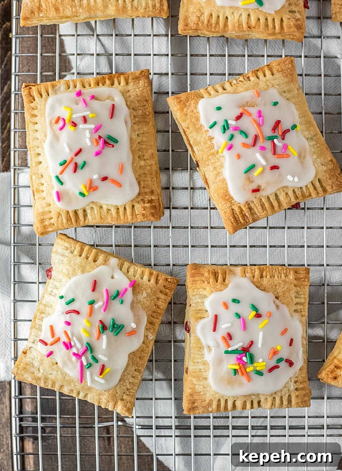Homemade Strawberry Pop-Tarts Recipe: Flaky Pastry with Sweet Filling 3 overhead shot of homemade pop tarts on wire cooling rack