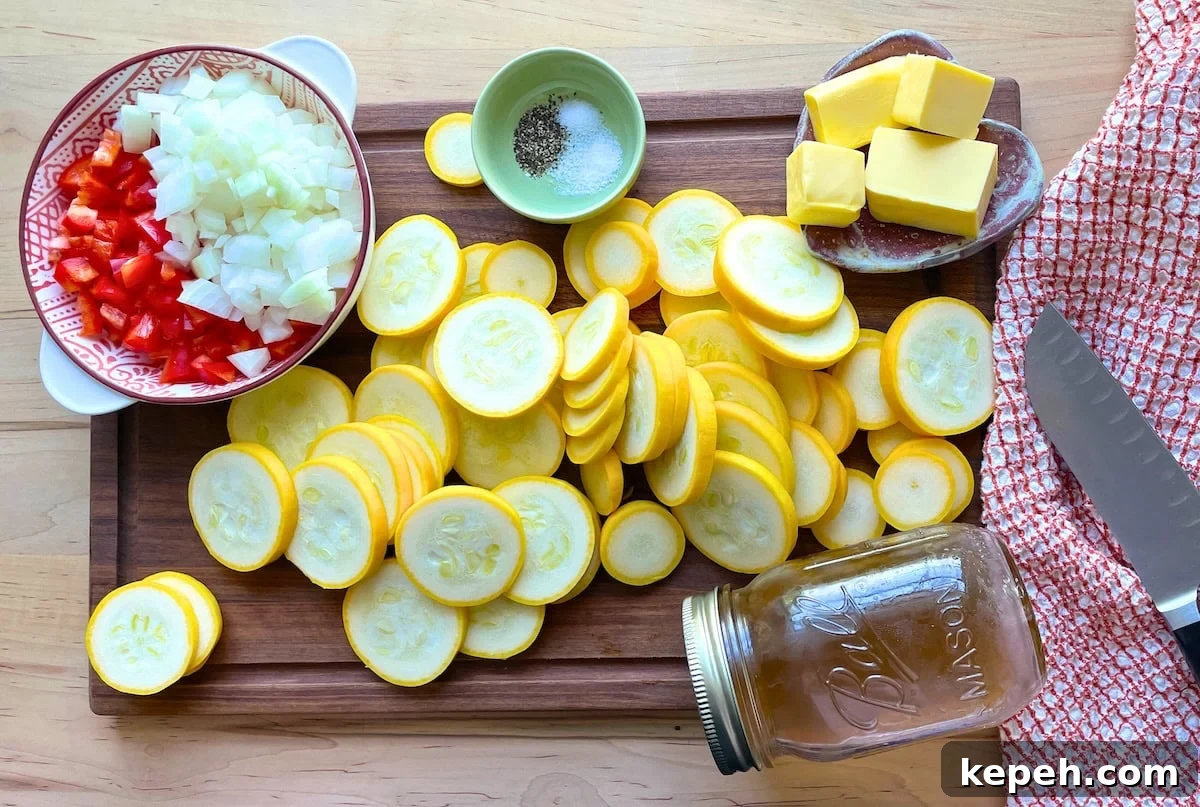 The ingredients in buttery squash on a cutting board - sliced yellow squash diced onion, red bell pepper, butter, salt, pepper, sugar, and chicken stock.