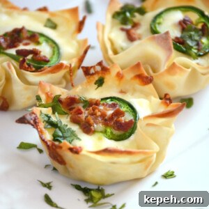 Bacon Jalapeño Popper Wonton Cups — Crispy Bite-Sized Appetizers 9 jalapeno popper wonton cups with bacon on a plate