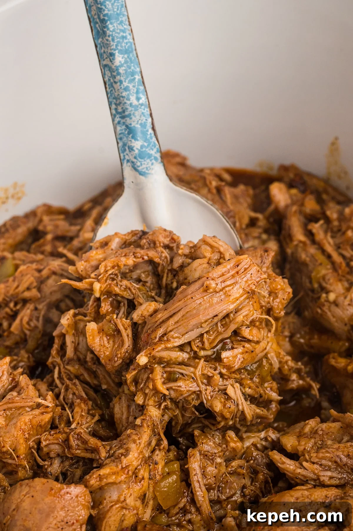 Cafe Rio Sweet Pork Recipe: Copycat Carnitas with Tangy Sauce 2 spoon of cafe rio pork in slow cooker.