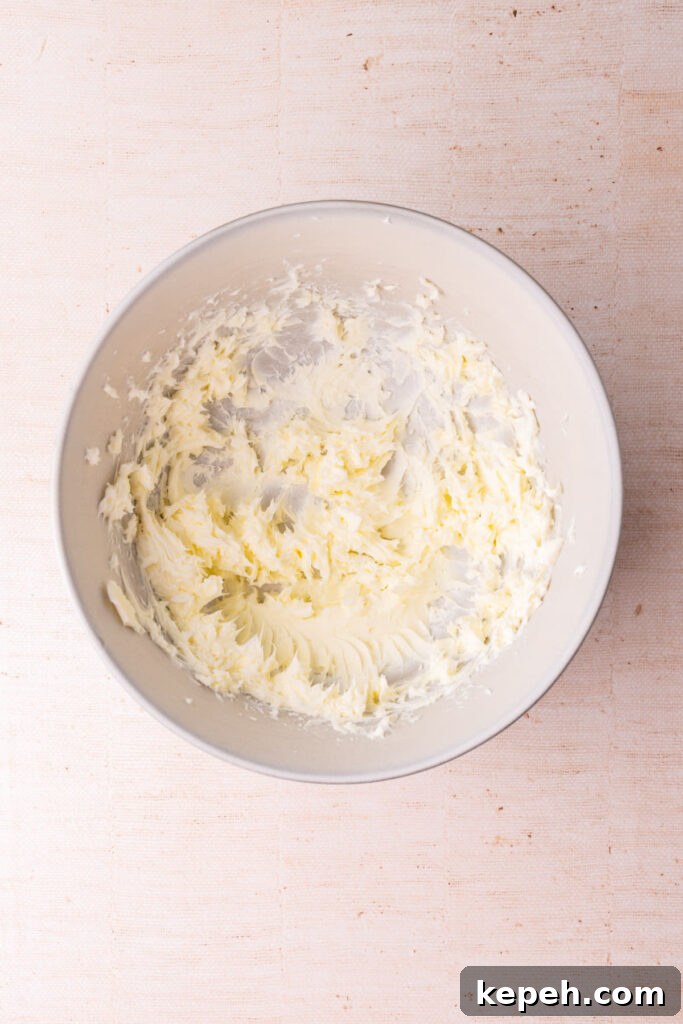 Softened butter whipped with a hand mixer in a large mixing bowl. 