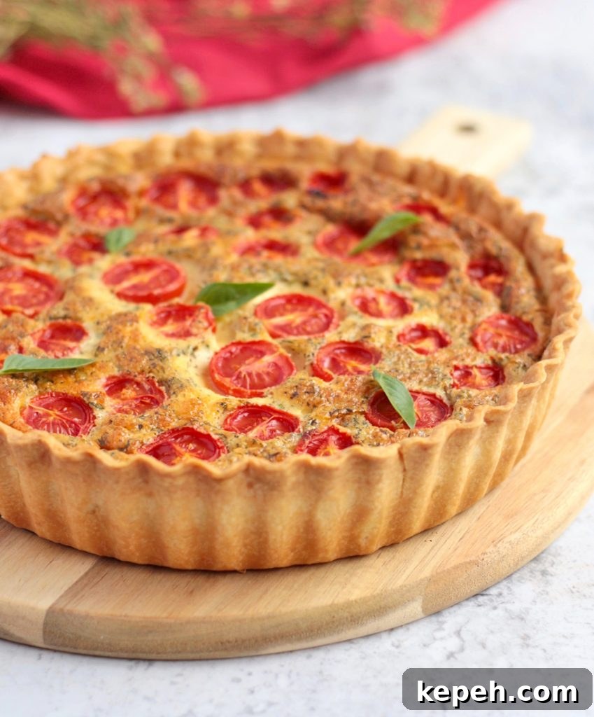 Side view of the tomato quiche on a wooden board