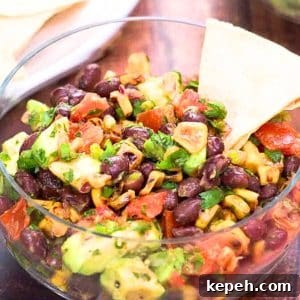 Fresh Avocado Salsa with Corn & Black Beans — Zesty Summer Dip 11 Avocado Corn Salsa served as a chip dip appetizer with tortilla chips on the side. Hostess At Heart
