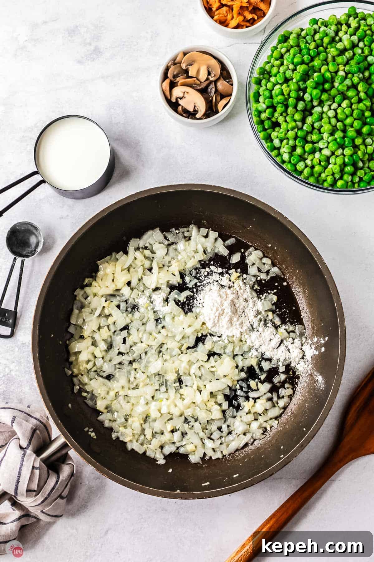 Classic Green Pea Casserole Recipe for Family Dinners 4 skillet with onion cooking with flour sprinkled on them